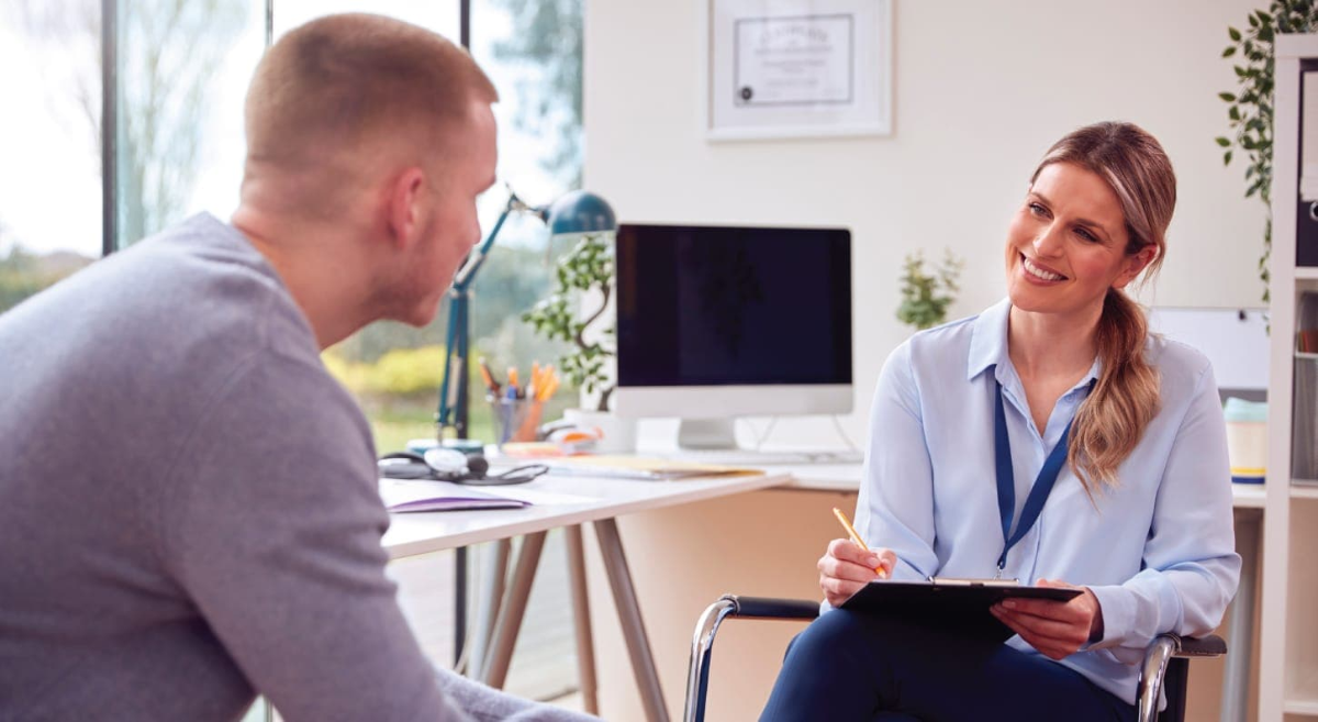 young person talking to someone in an office setting